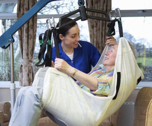 Elderly Woman in a Hoist Safe use of hoist and sling.